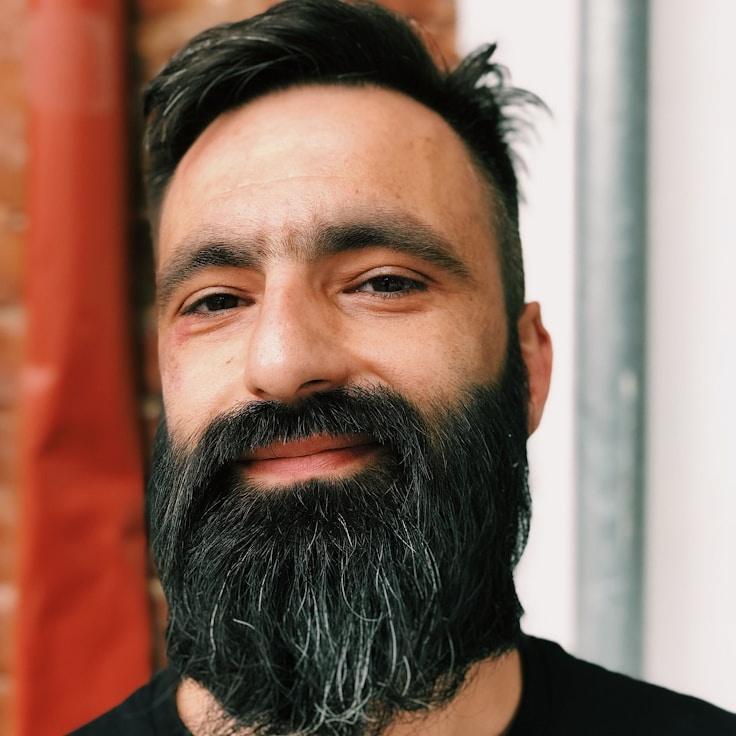 Kaveri Mehta, Lead Design Curator at Collect Plain Voyage, reviewing corporate floral arrangements